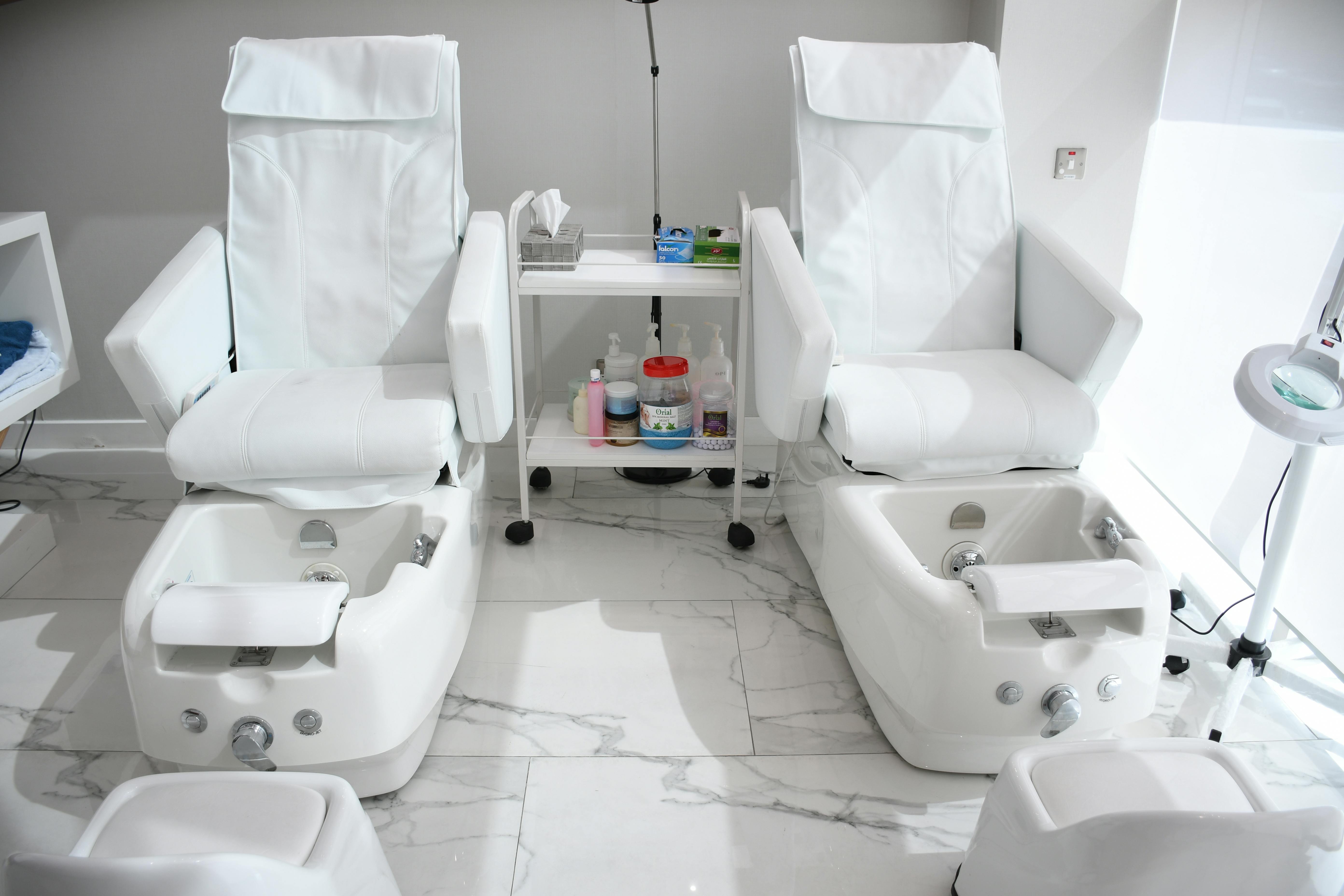 pexels-photo-4967906-4967906 Elegant white spa chairs ready for pampering treatments in Abu Dhabi salon.